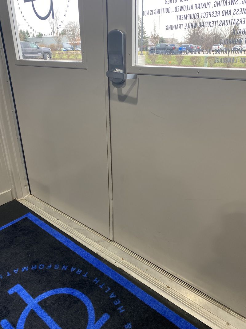 Commercial double steel entry doors with a sealed threshold at a business